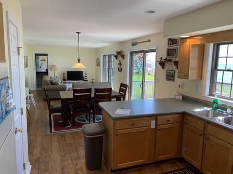 View of kitchen, dining area, and living room all overlooking the lake 