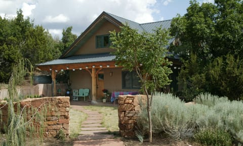 Relax and dine under the front portal in the garden setting.
