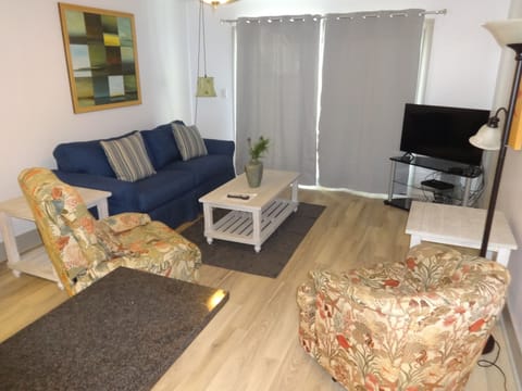 Living Area with a Queen Size Sleeper Sofa, Recliner and Swivel Chair