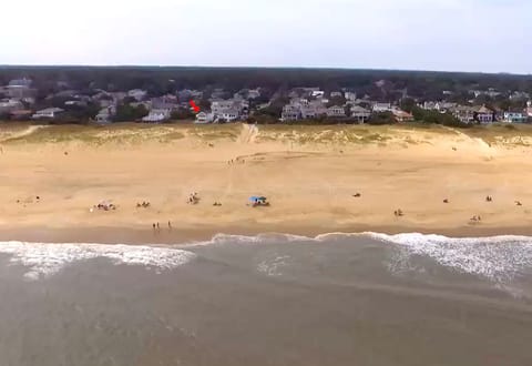 Beautiful wide beach at the North End. Red arrow shows the house location.