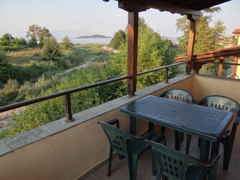 The big covered balcony of the living room with sea view and outdoor furniture 