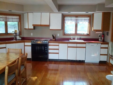 Modern Kitchen, open to Dining Room, Lake and Forest Views.