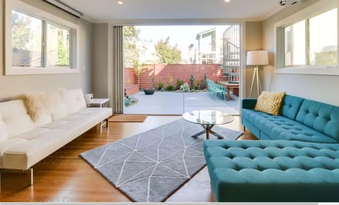 Downstairs media-family room with patio door/wall fully open to garden
