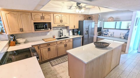 Kitchen with new stainless steel appliances and countertops + daybed