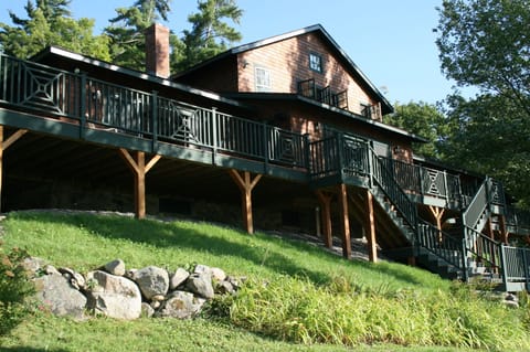 Front of house and deck...stairs lead down to flat lawn and tennis court.