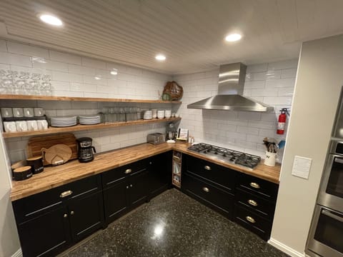 Double ovens, 6 burner stove, microwave, dishwasher, several small appliances