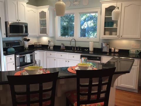 Granite counters and updated stainless appliances in the gourmet kitchen