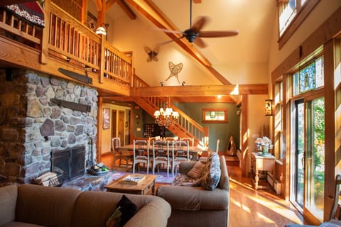 Open plan with fireplace, TV seating and Farm Table with Adjoining Patio