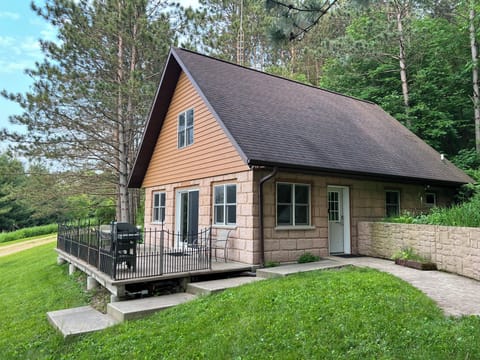 Stairs from the parking area lead to the cabin entrance.