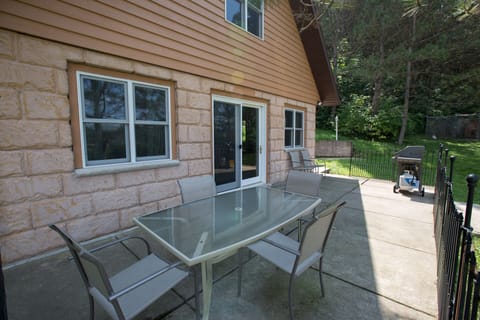 Patio seating for 6 with a gas grill.