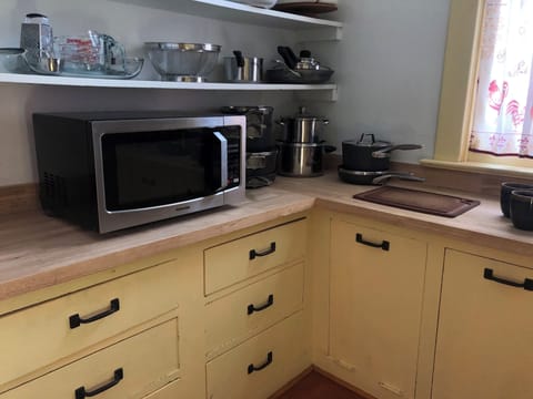 Walk-in pantry with butcher block countertops.