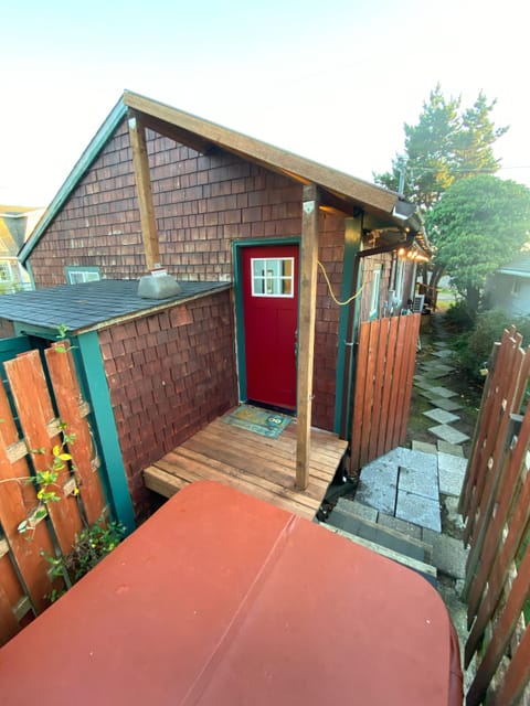 Covered back porch to watch kids while they’re in the Hot Tub.