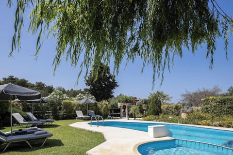 The pool area offers plenty of space for both swimming and socializing, with inviting sitting zones nearby.