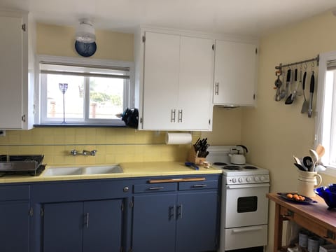 Kitchen with original tile and cabinets.