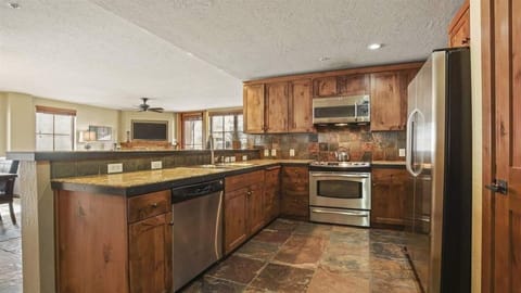 Large open kitchen with microwave, oven, stove top, refrigerator, and dishwasher
