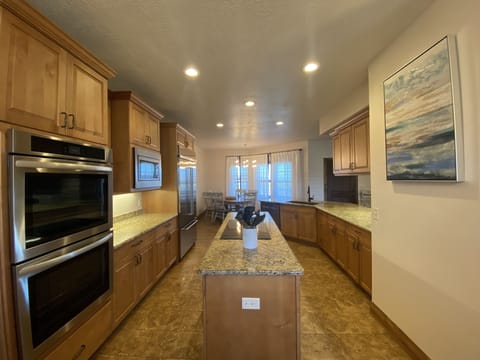 Updated kitchen. New appliances, 84" fridge, double ovens, cooktop in island