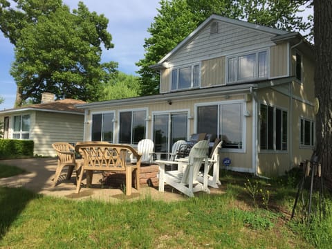 Quaint patio with Adirondacks, bench seating, picnic tables, firepit and grill.
