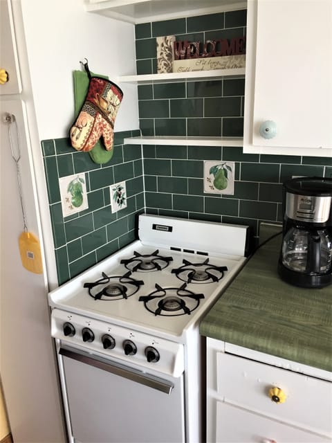 Galley kitchen features a petite natural gas stove 