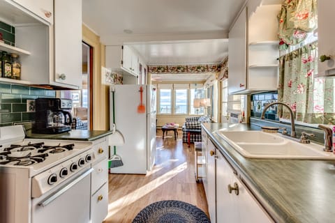 Vintage galley kitchen (with dishwasher!) is open to living and dining areas