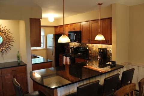 Gourmet kitchen has custom maple cabinets with granite countertops.