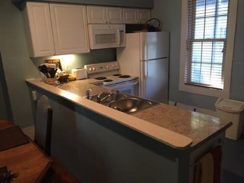 Full kitchen and large dining table.