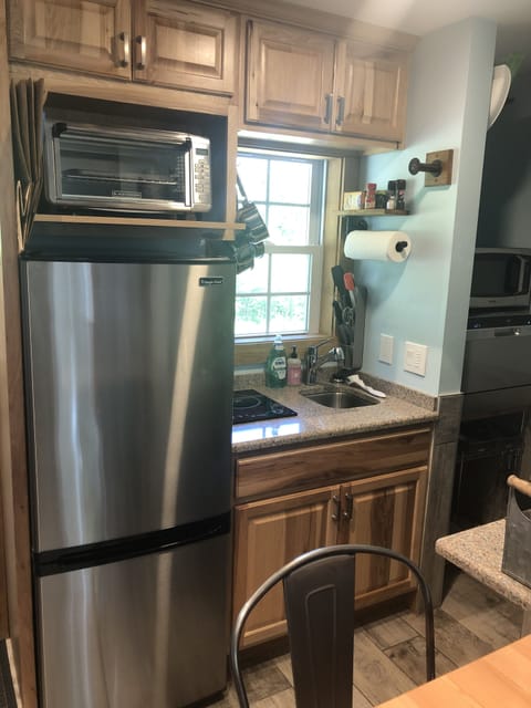 Kitchen w/fold down table (Frig, Oven, Microwave & Induction Burner)
