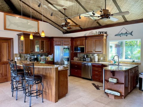 Custom mahogany kitchen with ice maker.