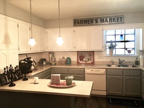Kitchen area open to dining area w/counter height bar for sitting/serving.