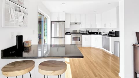Nicely equipped kitchen with stainless appliances and breakfast bar
