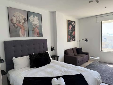 This open-plan layout seamlessly combines a cozy bedroom with a comfortable bed and a relaxing living area with a plush sofa. Enjoy the best of both worlds in one convenient and inviting space, perfect for unwinding after a long day.