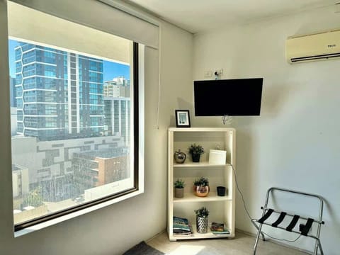 Modern, sunlit apartment with city views, a cozy reading nook, and all the essentials for a comfortable stay.