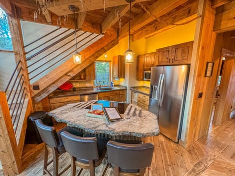 Steel bars, beautiful concrete counters & black walnut that accent the kitchen.