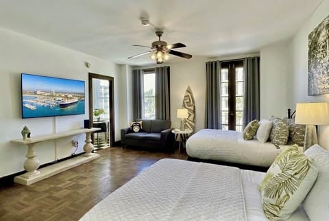 Spacious room with 2 full beds, sofa, Smart TV, WIFI and balcony access. 