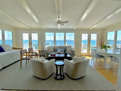 Beautiful sunroom with RH chairs and rug, West Elm sofa