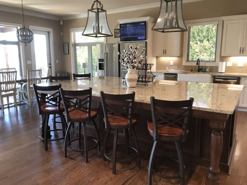 Large kitchen island with 6 bar stools.