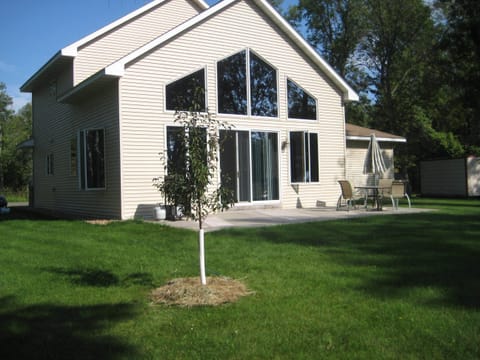 Back of cabin and patio with gas grill