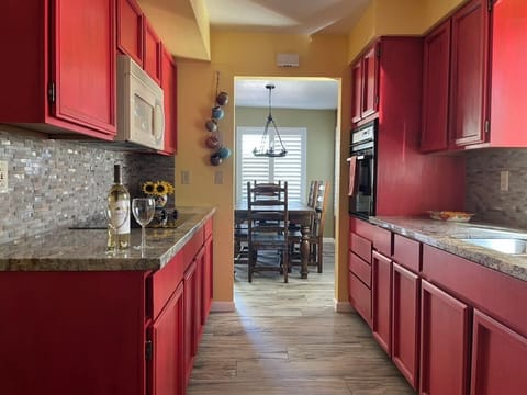 View of galley kitchen into dining room