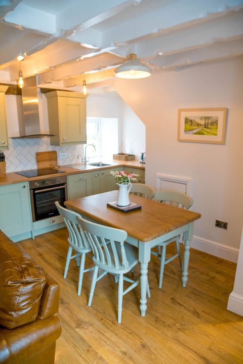 Handmade dining table and local artists painting of Colby Woodland Gardens.