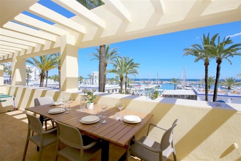 Large and sunny terrace facing south with outdoor dining area and sea views