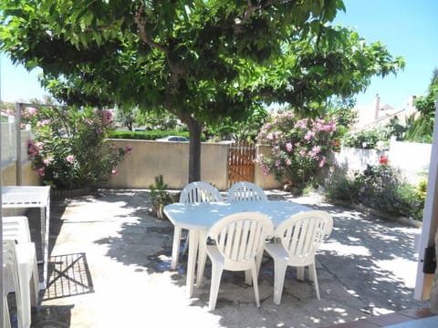2nd covered terrace with a table and garden furniture