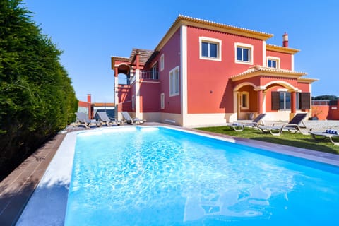 Outdoor swimming pool surrounded by a garden.