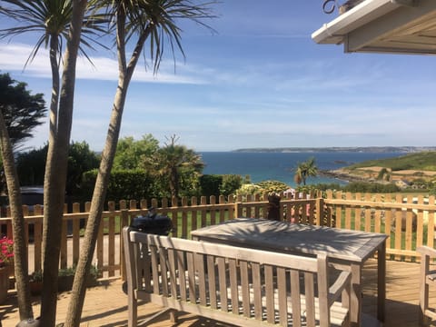 Enclosed decking area with outdoor tables and benches