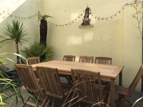 Mediterranean style patio garden with Teak table seating 8