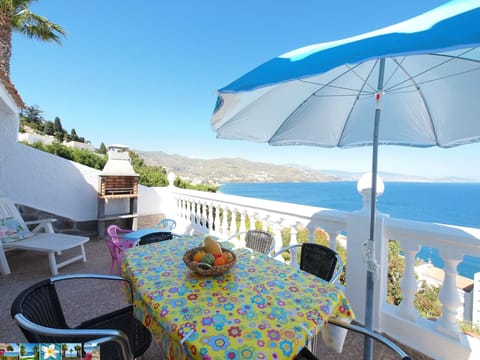 Terrace with dining table and barbecue