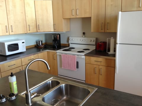 Kitchen with range, refrigerator, dishwasher, microwave, coffee maker, toaster..