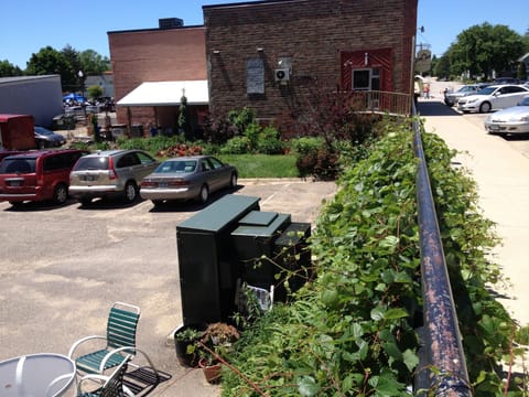 Parking & flower garden behind building.