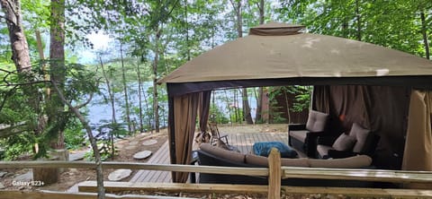 Gazebo with new outdoor furniture, hammock, protection from rain and has screen