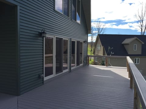 Front deck, w/out table, chairs and grill. Faces west, warm & sunny most days