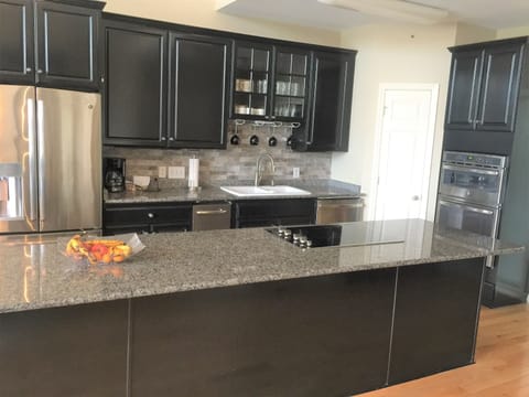 Spacious kitchen with range on island keeps everyone connected while cooking