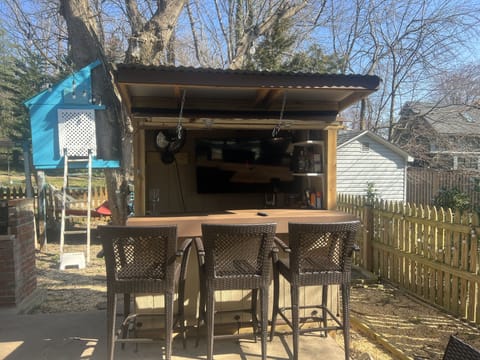 outdoor bar with flatscreen and frig 